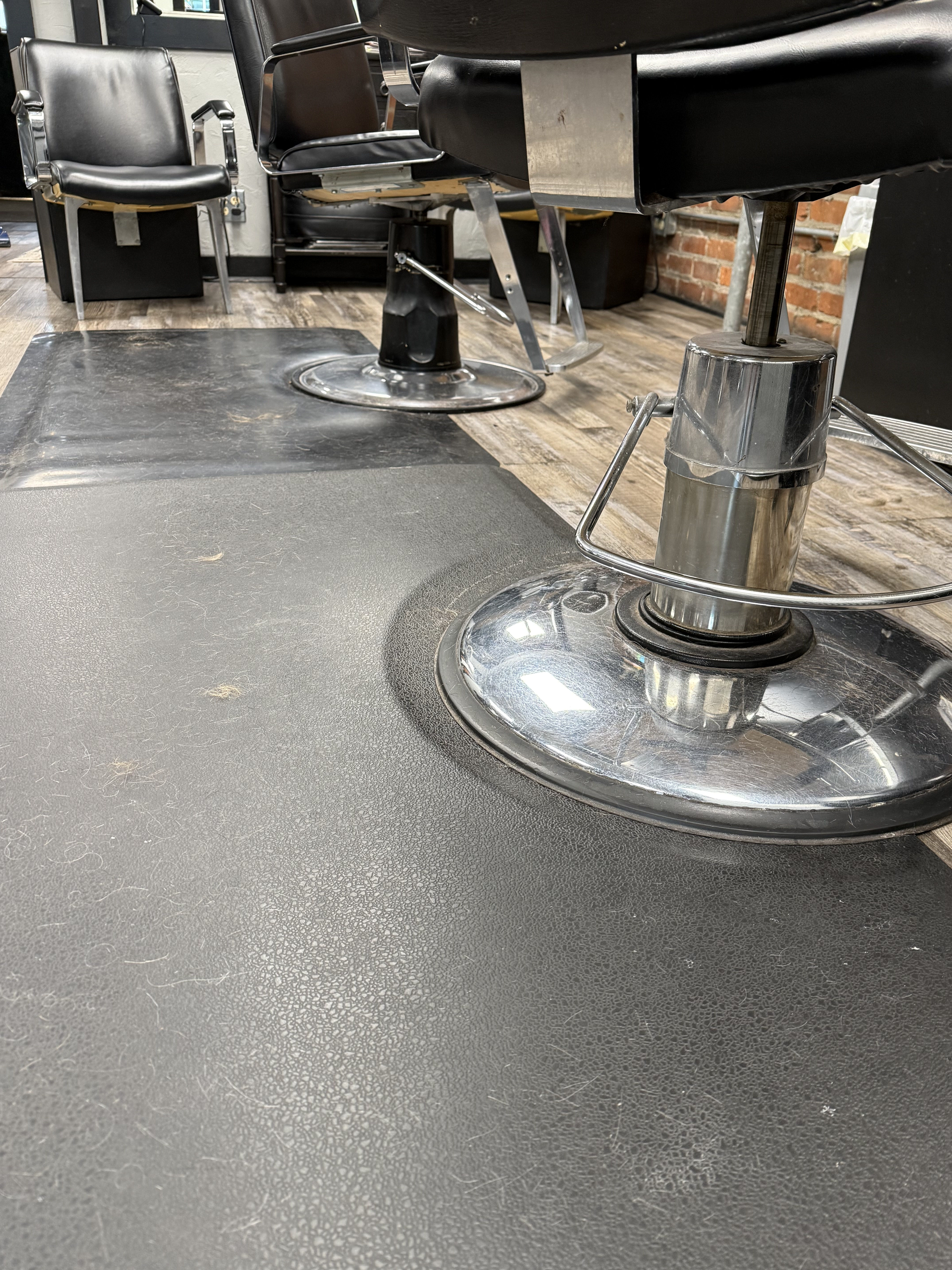 Barber shop floor before cleaning